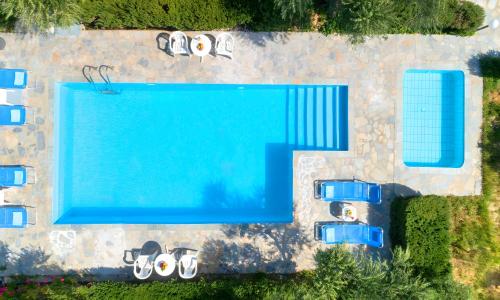 an overhead view of a swimming pool with cars parked around it at Plaisir Beachside Apts in Agios Nikolaos