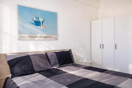 a bedroom with a bed and a painting on the wall at Cuore Flat in Modica