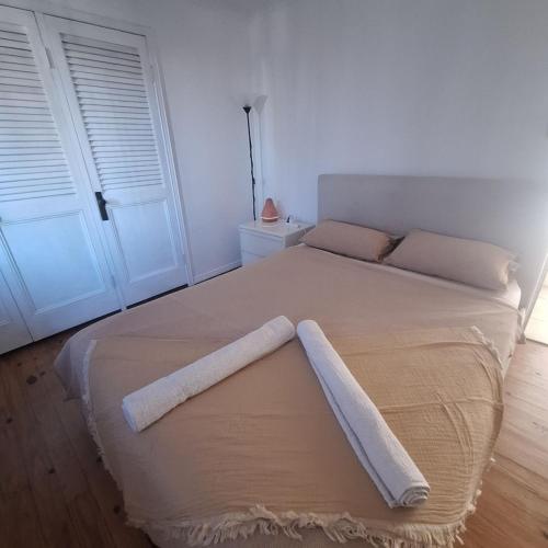 a bedroom with a large bed with two white doors at Exclusive Sunrise Room, GC Blues Festival, Cool Autumn, Fire Pits, Fishing in Gold Coast