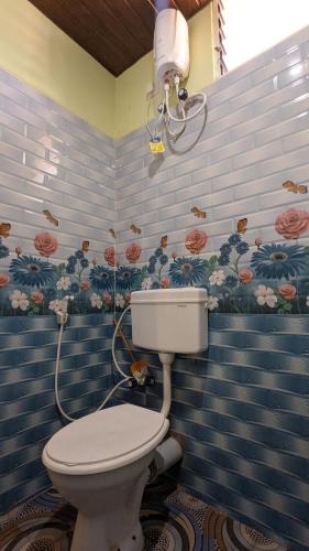 a bathroom with a toilet in a room at Coco Beach Front Stay & Cafe in Gokarna