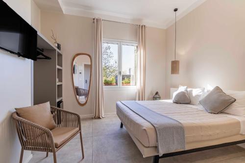 a bedroom with a bed and a chair and a mirror at Le Valli in Pellestrina