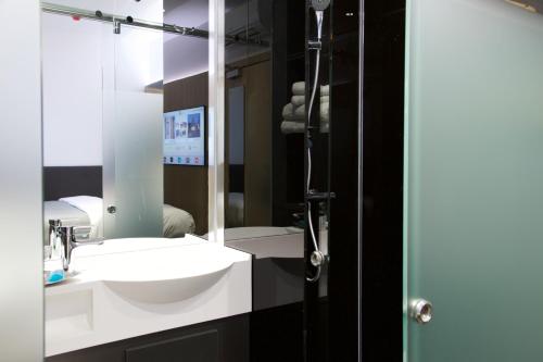 a bathroom with a sink and a mirror at The Z Hotel City in London
