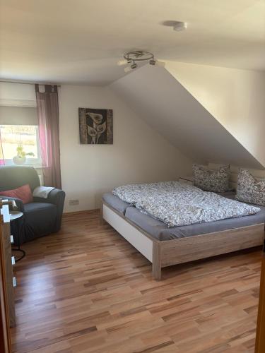 a bedroom with a bed and a couch at Ferienwohnung Schaller in Berg