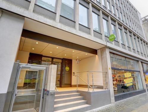 an entrance to a building with a revolving door at hub London Tottenham Court Road - Goodge Street in London
