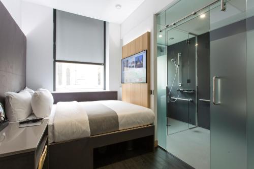 a hotel room with a large bed and a large window at The Z Hotel City in London