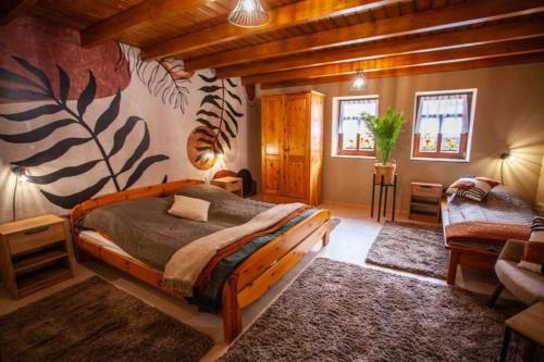 a bedroom with a large bed in a room at Nagyon Vadon vendégház in Háromhuta