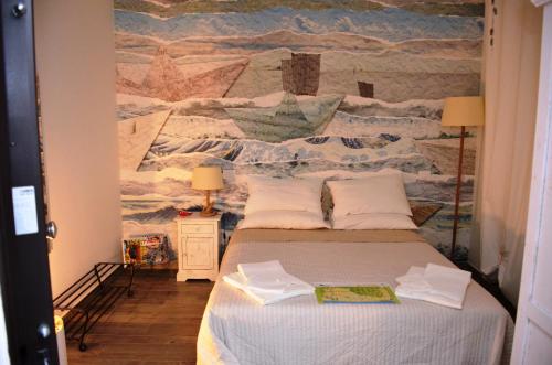 a bedroom with a bed with a mural on the wall at La Sciabbega B&b in Porto Recanati