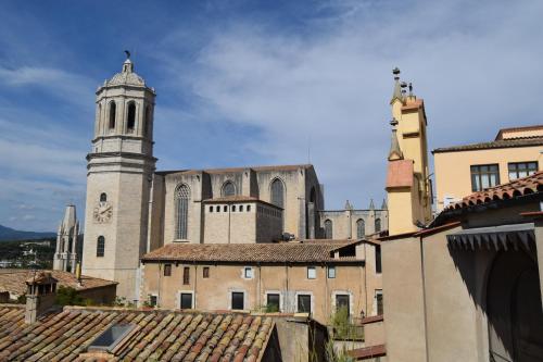 a large church with a tower and a clock at Hotel Històric in Girona