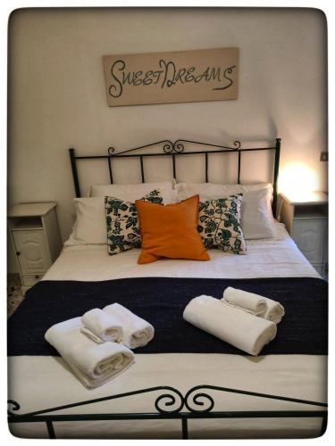a bed with towels and pillows on it at B&B il Faso vicino Zoosafari di Fasano in Fasano