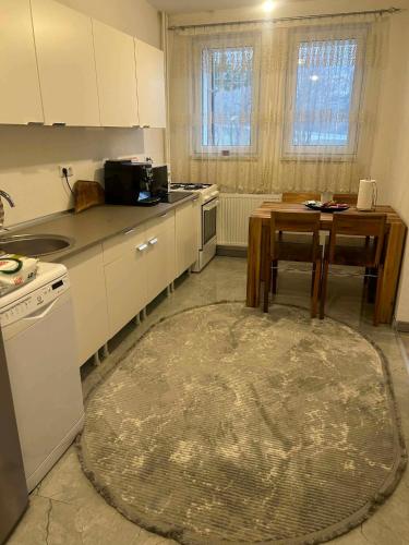 a kitchen with a table and a table sidx sidx sidx sidx at Stan Krndija - Tesanj in Tešanj