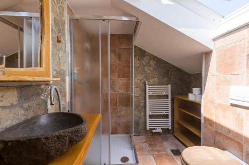 a bathroom with a tub and a shower at Rooms Murka in Bled