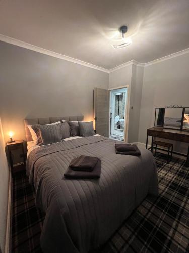 a bedroom with a large bed with two towels on it at Longshore Drift in Woodhorn