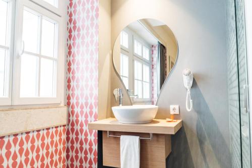 a bathroom with a sink and a mirror at Stay Hotel Lisboa Centro Chiado in Lisbon
