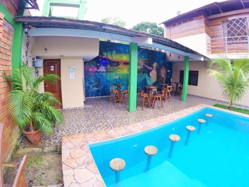a house with a swimming pool in front of it at Amazon City in Pucallpa