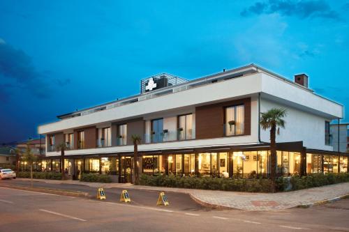 a white building with palm trees in front of it at Casa Bianca Hotel in Denizli