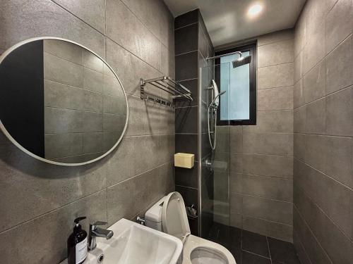a bathroom with a sink and a toilet and a mirror at Le Cozy Cabin - 2B2R SeaCity View Infinity Pool in George Town