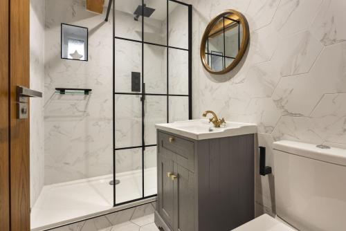 a bathroom with a sink and a shower at 1 Force Mill Barn - Ridgestone in Ulverston