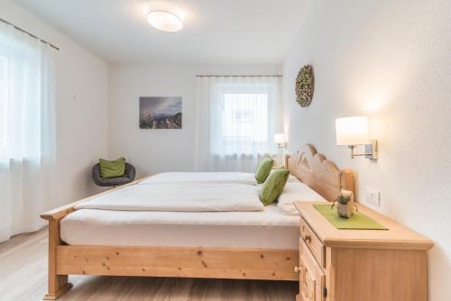 a bedroom with a large bed and a table at Ferienwohnung Eder in Gais