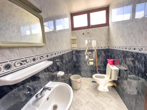 a bathroom with a sink and a toilet at Tamraght Waves Retreat 2 in Tamraght Ouzdar