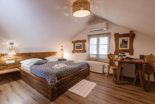 a bedroom with a large wooden bed and a desk at Rooms Murka in Bled