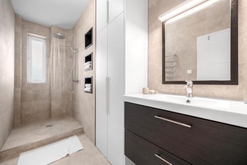 a bathroom with a sink and a shower at Modern old town apartment in Bratislava