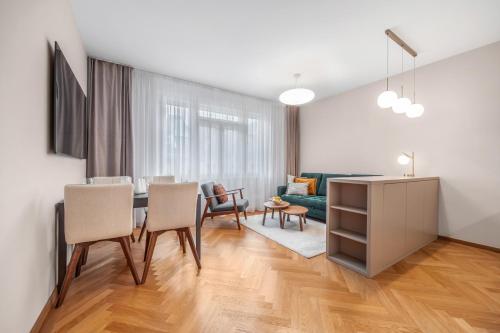 a living room with a table and chairs and a couch at Modern old town apartment in Bratislava
