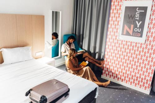 a group of people in a hotel room with a bed at Stay Hotel Lisboa Centro Chiado in Lisbon