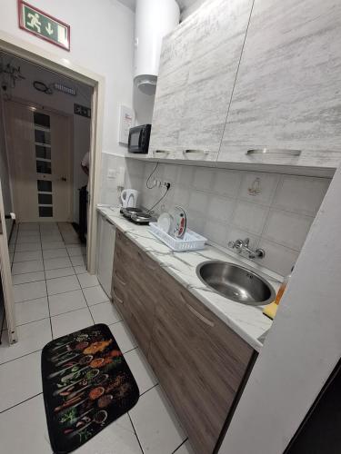 a kitchen with a sink and a counter top at Lovely Paceville Studio E in St. Julianʼs