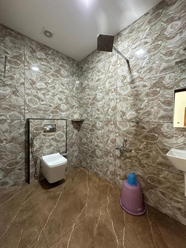 a bathroom with a toilet and a sink at Mount court munnar in Munnar