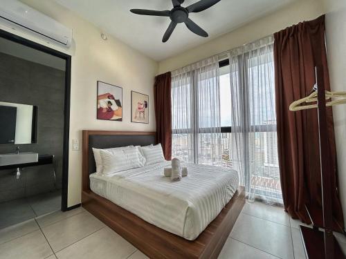 a bedroom with a bed with a teddy bear on it at Le Cozy Cabin - 2B2R SeaCity View Infinity Pool in George Town