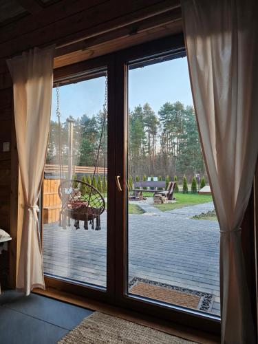 a sliding glass door with a view of a patio at Leśne Zacisze Radawa I in Radawa
