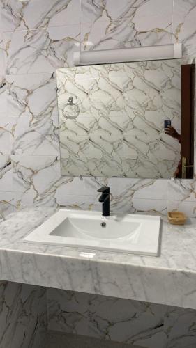 a bathroom with a white sink and a mirror at Big Villa In Rabat in Rabat