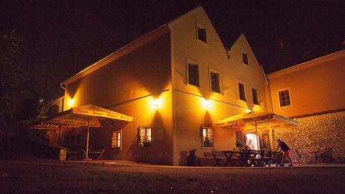 a person standing outside of a building at night at Penzion Zatisi in Mikulov