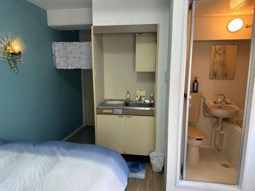 a small bathroom with a sink and a toilet at Peace Wing 3C in Hiroshima