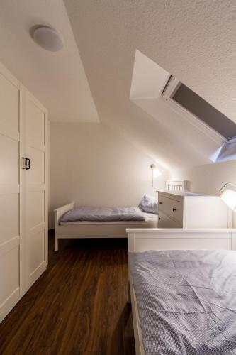 an attic bedroom with two beds and a closet at Ferienwohnung "Mour" in Dahme