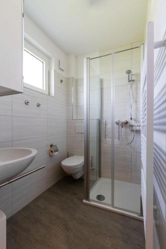 a bathroom with a shower and a toilet and a sink at Ferienwohnung "Mour" in Dahme