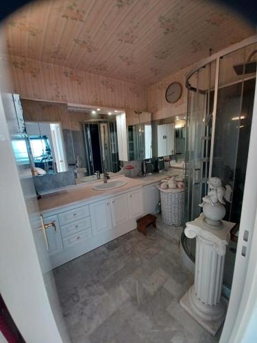 a large bathroom with a sink and a toilet at Appartement vue mer in Saint-Raphaël