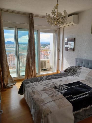a bedroom with a bed and a large window at Appartement vue mer in Saint-Raphaël