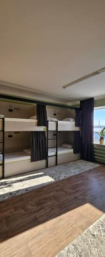 a bedroom with two bunk beds with a window at Koktem hostel in Aktobe