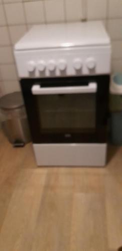 a white oven sitting on top of a wooden floor at appartement de Groote Peel in Nederweert
