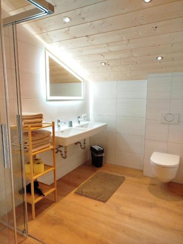 a bathroom with a sink and a toilet at Ferienwohnungen Tauernalm in Heiligenblut