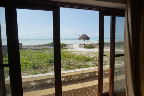 a view of the beach from the window of a room at White Sands in Paje