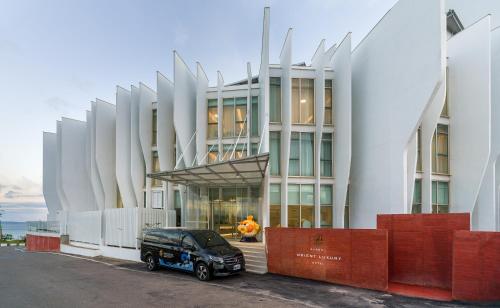 a black truck parked in front of a building at Orient Luxury Hotel Kenting in Hengchun South Gate