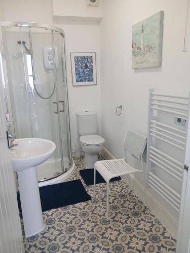 a bathroom with a shower and a sink and a toilet at Rowntree Seaview Holiday Apartments in Bridlington