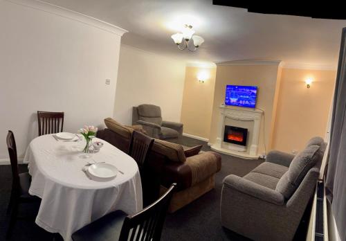 a living room with a table and chairs and a tv at Vicky and sons Ltd Sunderland in Monkwearmouth