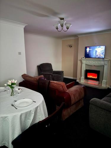 a living room with a couch and a fireplace at Vicky and sons Ltd Sunderland in Monkwearmouth
