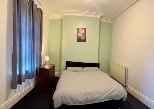 a bedroom with a white bed and a window at Vicky and sons Ltd Sunderland in Monkwearmouth