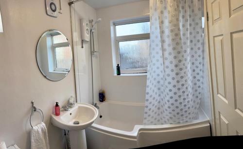 a bathroom with a shower curtain and a sink at Vicky and sons Ltd Sunderland in Monkwearmouth