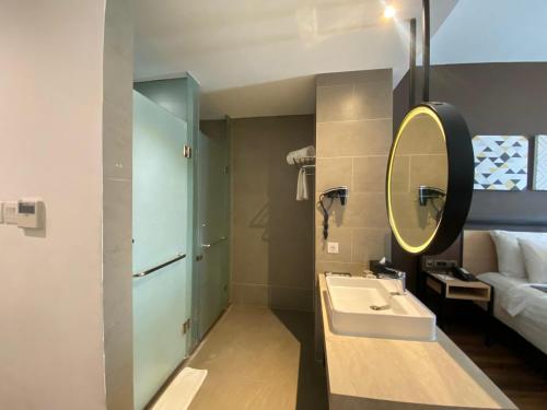 a bathroom with a sink and a mirror at Muraya Hotel Aceh in Banda Aceh