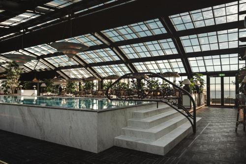 a swimming pool with stairs in a building at Rox Resort in Køge